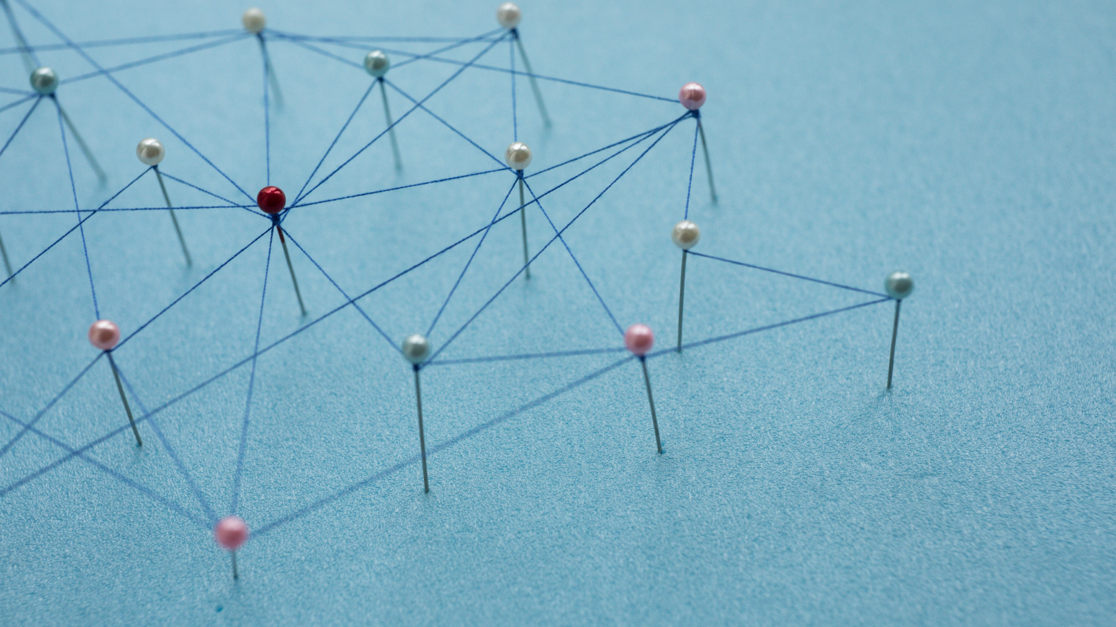 pins in paper connected by string